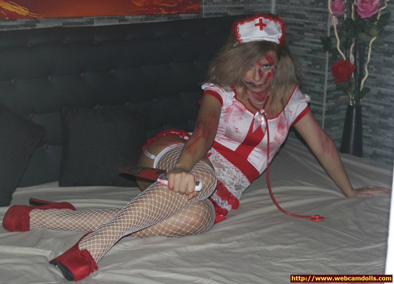 Blonde Girl wearing Nurse Costume and White Fishnet Stockings on Webcamdolls